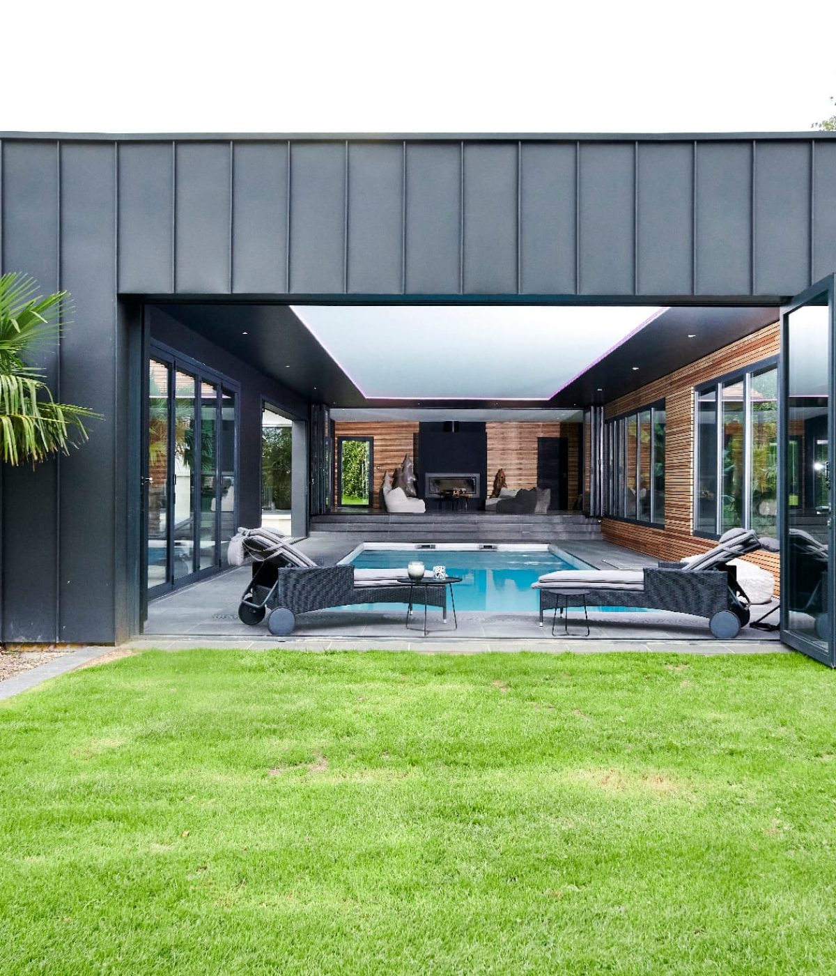 Piscine intérieure de 11 x 4m à fond plat. Volet immergé caillebotis immergé en bois exotique Ipé